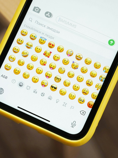 Decorative image of a phone keypad showing lots of emojis