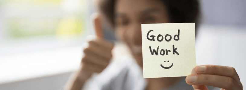Post-It note with "Good Work" and a smiley face drawn on it